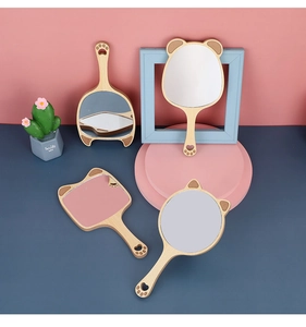 Detailed view of wooden handheld mirrors in round, square and bear-ear shapes with paw cutout