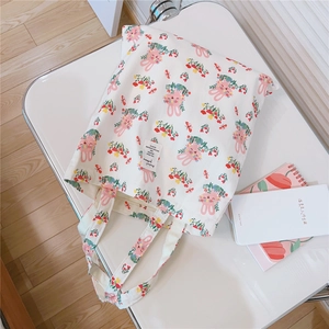 Close-up of cute pink rabbit pattern and woven label on white cotton canvas tote bag