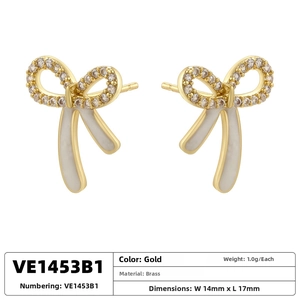 Detail showing white enamel bow earring with gold brass finish and zircon accents