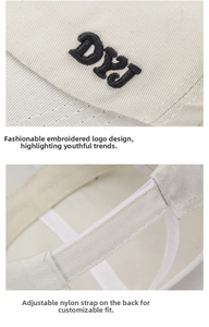 Detail of embroidered DYJ logo and adjustable magic tape closure on the cotton baseball cap