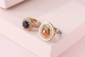 Detail of creative stainless steel rings with round micro-pave cubic zirconia on pink steps