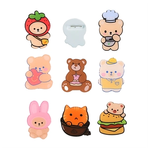 Set of 8 cute acrylic cartoon bear brooches in various designs on a white background