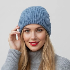 Blue waffle knit beanie hat with wide cuff design for winter warmth on gray background