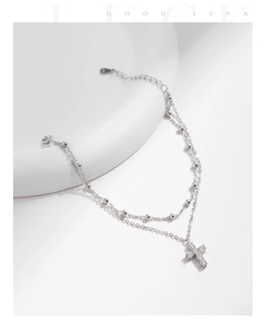 Detail of S925 sterling silver double-layered bracelet with sparkling cross pendant