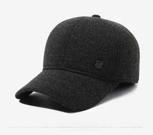 Detailed side view of dark grey wool blend winter cap with metal shield badge