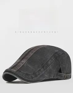 Detail of washed grey flat cap featuring side adjustable metal buckle and leather strap