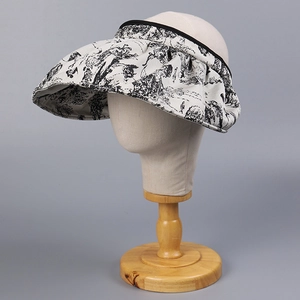 Detail of Toile de Jouy print on a wide brim open top sun hat for elegant summer sun protection