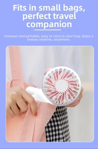 Mini cat fan being placed into a small pink bag to show portable and compact size