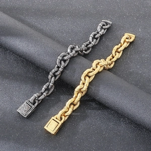 Detail of punk style chunky curb chain bracelets in vintage silver and gold finish