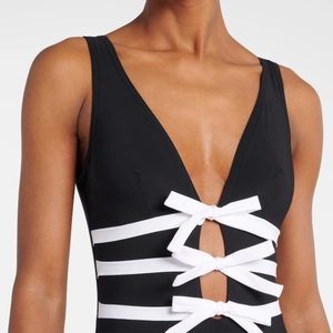 One-piece V-neck black swimsuit with white bow details and side cutouts for women