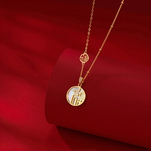 Detailed shot of a gold fortune pendant on red silk background with white shell inlay