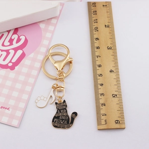 Detailed size measurement of a gold cat and music note keychain with enamel finish
