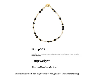 Detail view of OT toggle bead necklace with black agate and white shell pearls