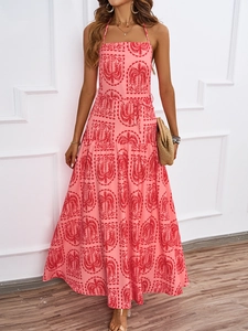 Close-up of pink halter maxi dress featuring red tropical palm trees and plaid patterns