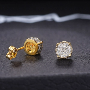 Macro shot of gold-plated hip hop stud earrings with micro-paved sparkling cubic zirconia
