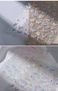 Holographic 3D butterfly nail stickers with rhinestones on beige stone background