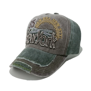 Detail of vintage washed baseball cap with 3D New York embroidery and distressed brim