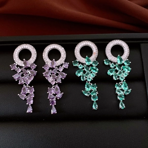 Detailed view of purple and green zircon tassel earrings with drop-shaped crystals