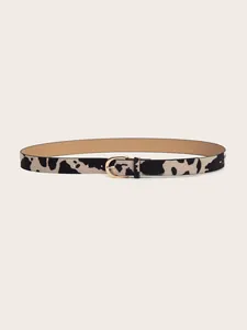 Detail of thin cow print belt featuring faux pony hair texture and gold oval metal buckle