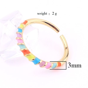Macro shot of 3mm gold-plated adjustable ring featuring colorful rainbow enamel pattern