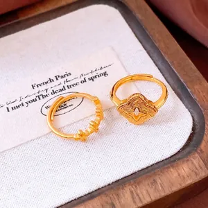 Vintage gold-plated floral ring set with clover and star patterns on a rustic backdrop