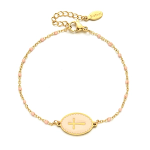 Detailed macro of gold stainless steel cross bracelet with pink enamel oval charm