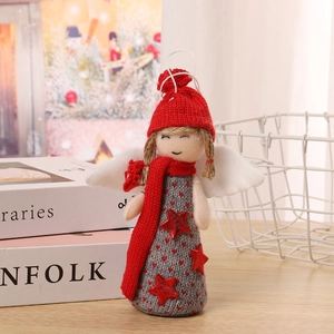 Detail of Christmas angel doll ornament with knitted red hat and white wings decor