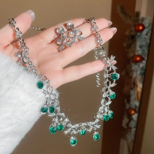Detailed shot of sparkling green waterdrop jewelry set with bow-knot crystal accents