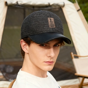 Winter baseball cap for elderly men in dark grey wool with leather brim and ear protection