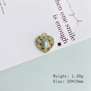 Detail of gold heart pendant with turquoise stone, hammered texture, 20x18mm size