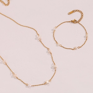 Detailed macro view of golden stainless steel chain with natural freshwater pearls