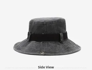 Side view of washed denim bucket hat with black decorative strap and metal eyelets