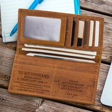 Brown leather wallet interior with multiple card slots and personalized engraved quote