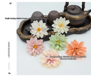 Detail of six assorted faux dahlia flower heads in soft pastel silk fabric textures