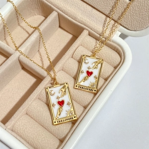 Detailed macro view of The Lovers tarot pendant with red heart and crystals in jewelry box