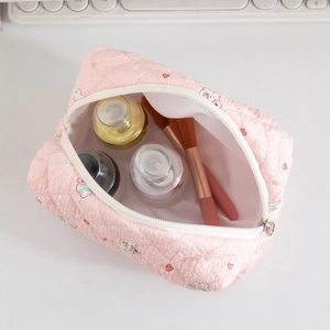 Pink quilted makeup bag with bear patterns showing large storage for cosmetics