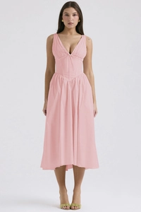 Detail of slim-fit pink dress featuring deep V-neckline and elegant corseted waist design