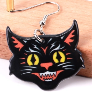 Detailed close-up of a Halloween black cat earring with yellow and orange printed patterns