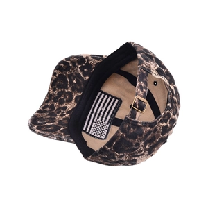 Leopard print baseball cap featuring an adjustable metal buckle and USA flag brim detail