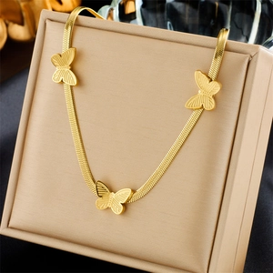 Gold snake chain necklace featuring three elegant butterfly charms on a cream display card