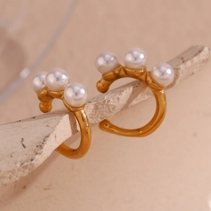 Detailed macro view of 18K gold plated ear cuffs featuring three white pearls on stone