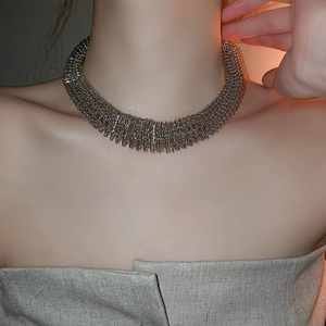 Close-up of silver chunky spring-link collar necklace in punk style on a model