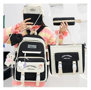 Detail shot of black and white 4-piece canvas backpack set with school accessories
