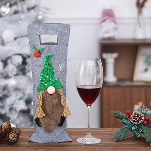 Detailed view of gray and green Christmas gnome wine bottle covers with sequins and fur