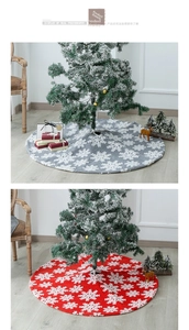 Detail of grey and red plush Christmas tree skirts with white snowflake embroidery