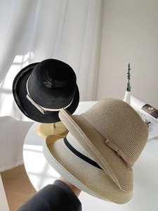Detailed weave of breathable straw sun hats with elegant bow ribbons in neutral colors