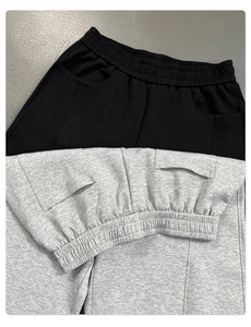 Close-up of elastic waistband and knit texture on black and grey casual pants