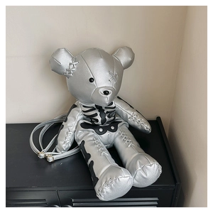 Close-up of silver lychee grain PU leather bear backpack with black skeleton prints