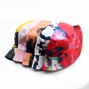 Detailed top view of five double-sided tie-dye bucket hats in various artistic colors