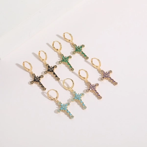 Detailed view of cross hoop earrings with black, green, turquoise, and purple stones